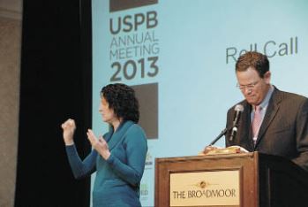 2012-2013 USPB Chair Sid Staunton goes through roll call while an interpreter signs the names for a deaf reporter